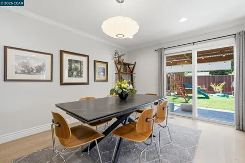 a living room with furniture a dining table with wooden floor