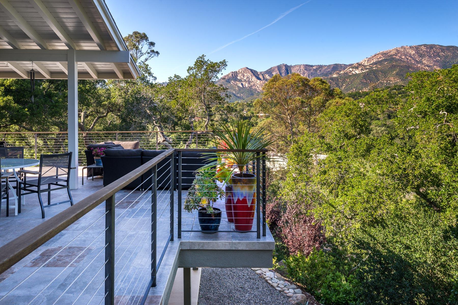 1702 Hillcrest Road Santa Barbara, CA 93103 - Photo 12 of 27 a view of a patio with a table and chairs under an umbrella with a small yard