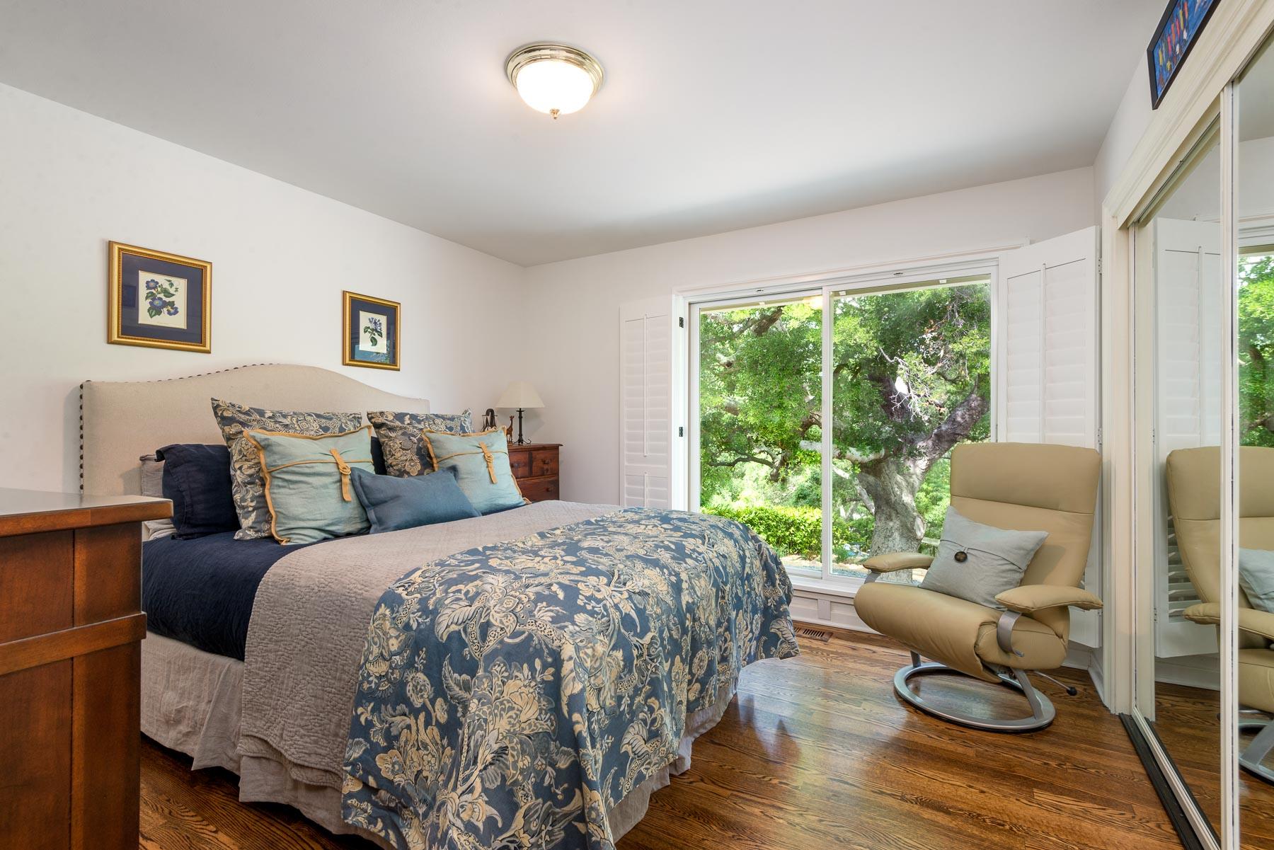 1702 Hillcrest Road Santa Barbara, CA 93103 - Photo 23 of 27 a bedroom with a bed and wooden floor