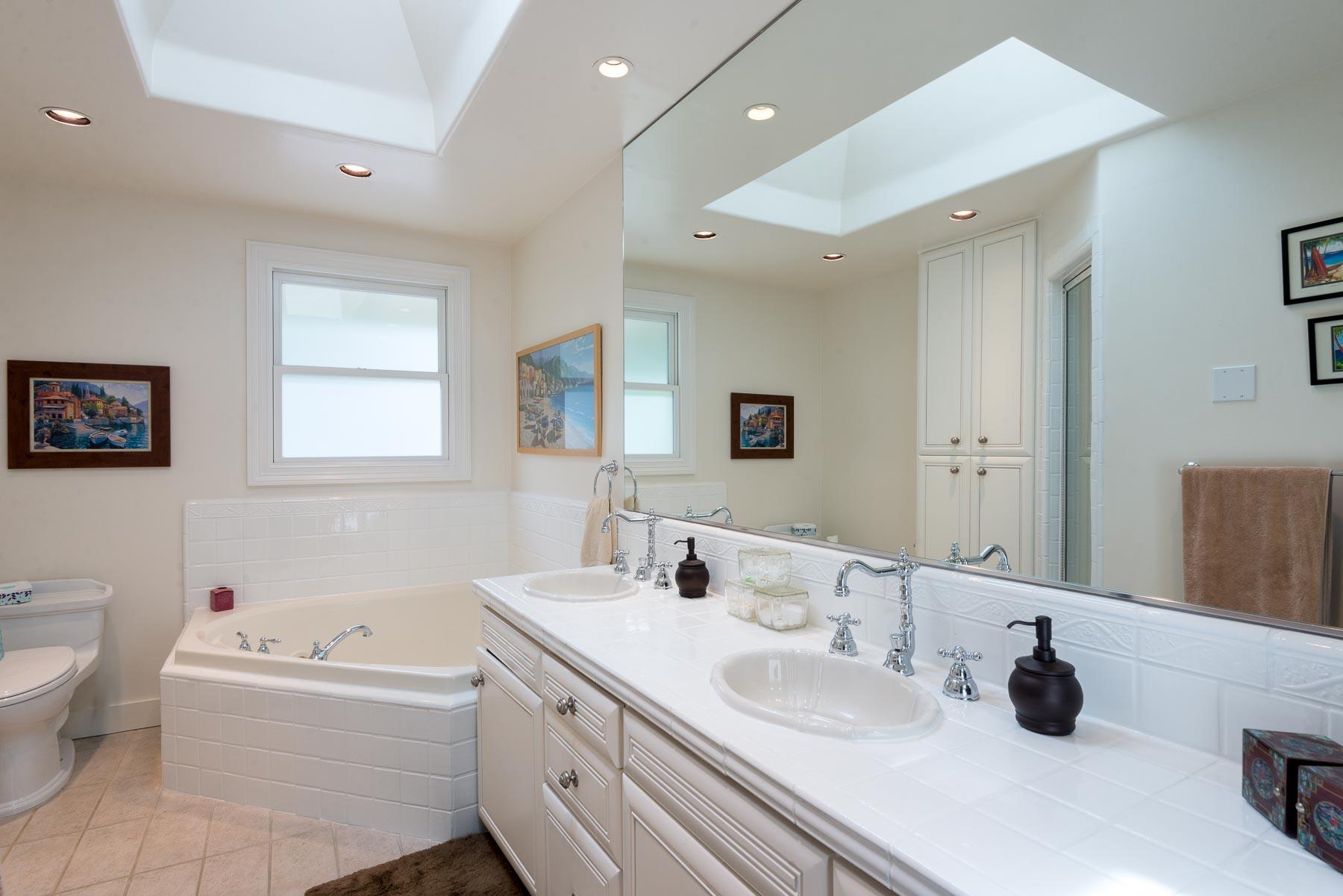 1702 Hillcrest Road Santa Barbara, CA 93103 - Photo 24 of 27 a bathroom with a granite countertop double vanity sink mirror bathtub and toilet