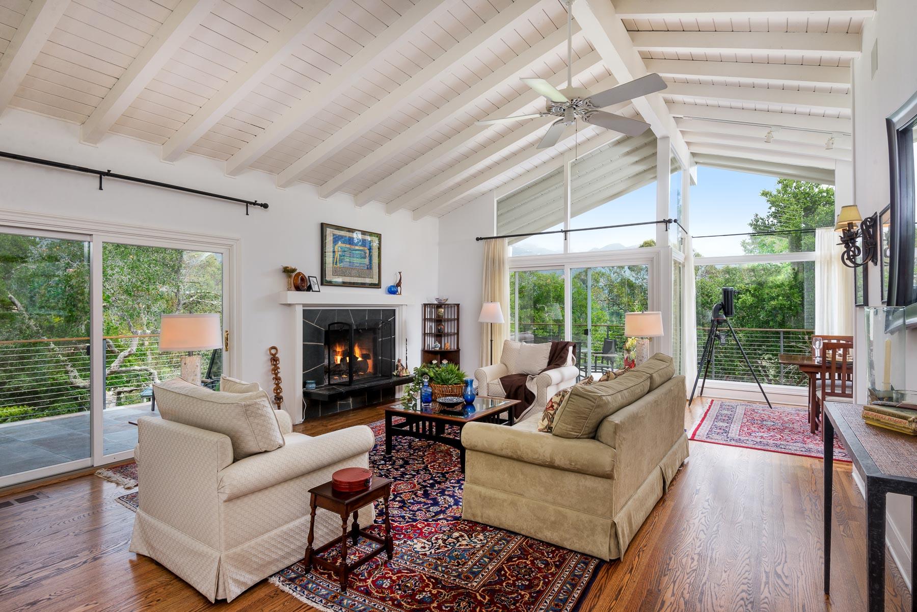 1702 Hillcrest Road Santa Barbara, CA 93103 - Photo 3 of 27 a living room with furniture a fireplace and a large window