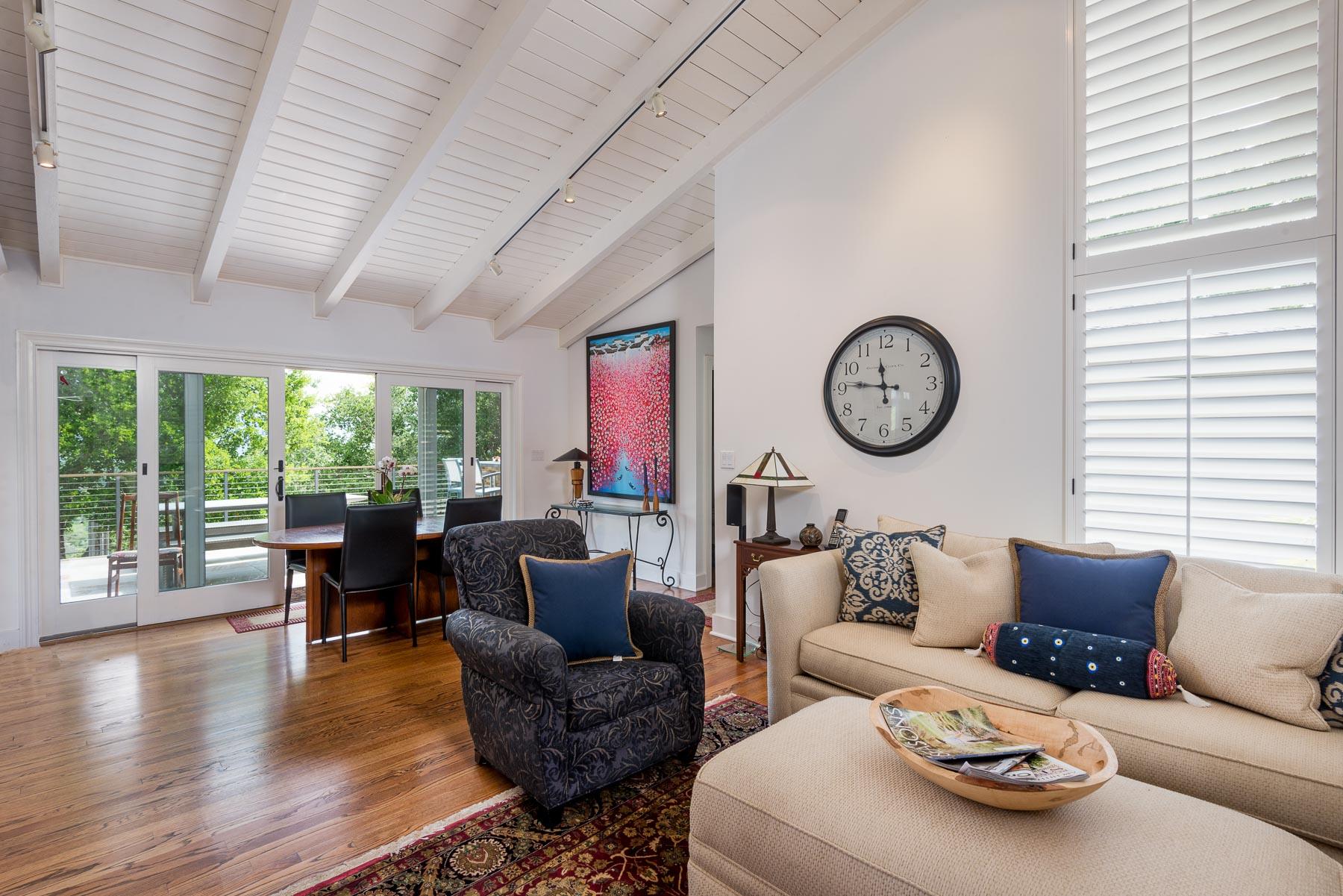 1702 Hillcrest Road Santa Barbara, CA 93103 - Photo 4 of 27 a living room with furniture a large window and a clock