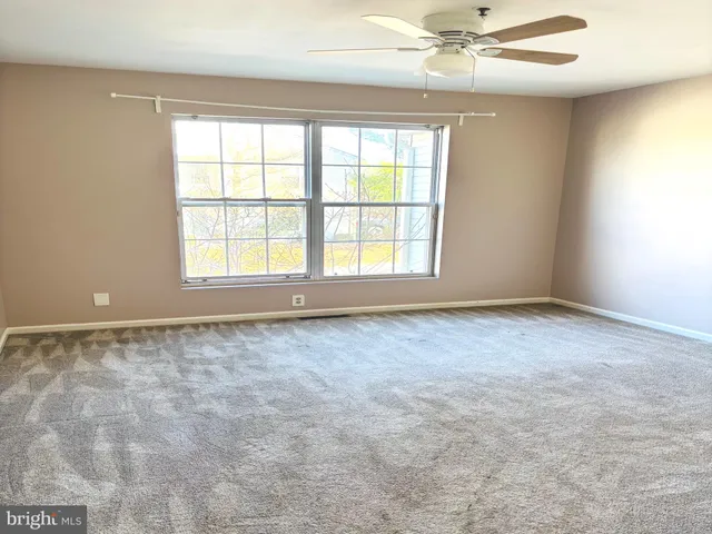 an empty room with a empty space and windows