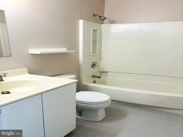 an empty room with a window and a ceiling fan