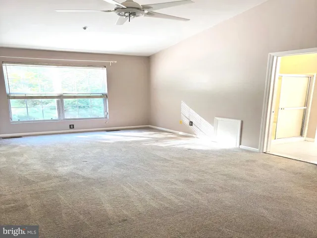 an empty room with windows and closet