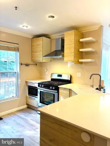 a kitchen with stainless steel appliances granite countertop a stove and a sink