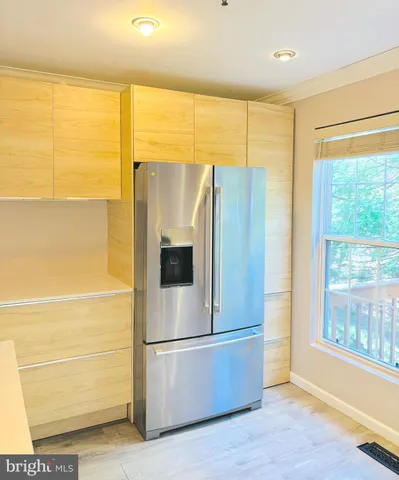 a kitchen with stainless steel appliances a refrigerator and a window