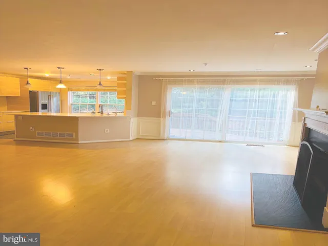 a view of an empty room with a fireplace