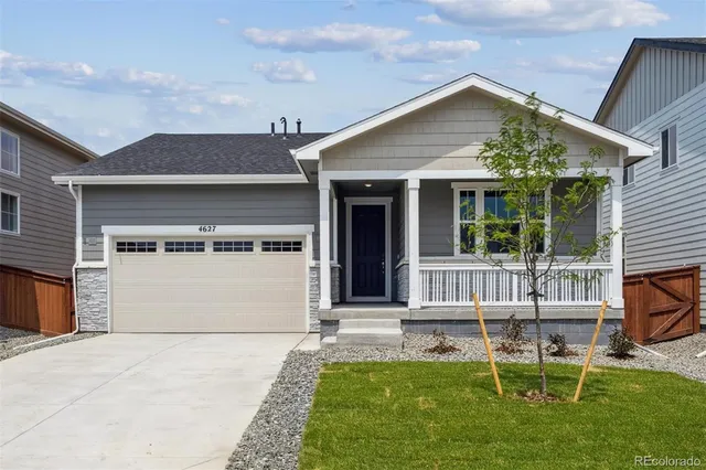 a front view of a house with a yard glass top table and chairs