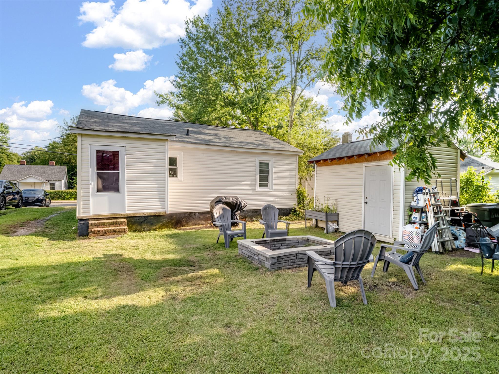 206 Friedheim Road Rock Hill, SC 29730 - Photo 21 of 25 a view of backyard of house with outdoor seating and trees in the background