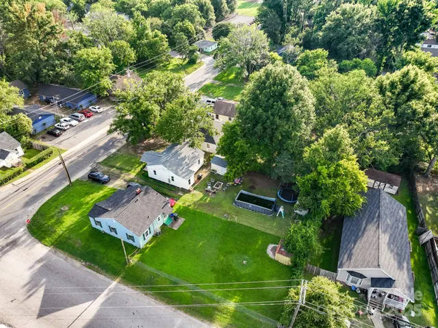 an aerial view of a house with garden space and street view