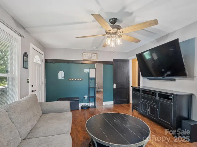 a living room with furniture and a flat screen tv