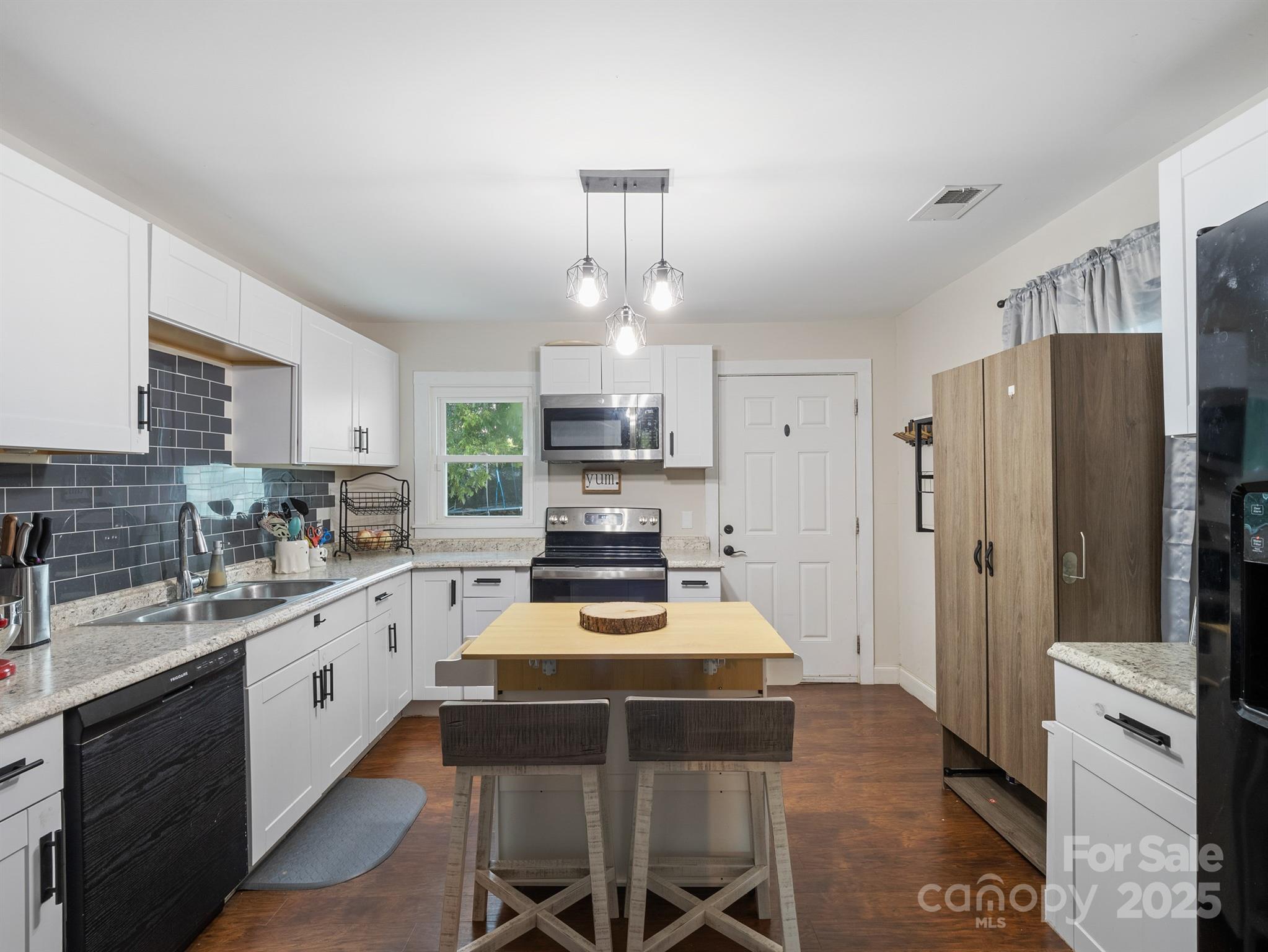 206 Friedheim Road Rock Hill, SC 29730 - Photo 8 of 25 a kitchen with a refrigerator a stove a sink dishwasher and white cabinets with wooden floor