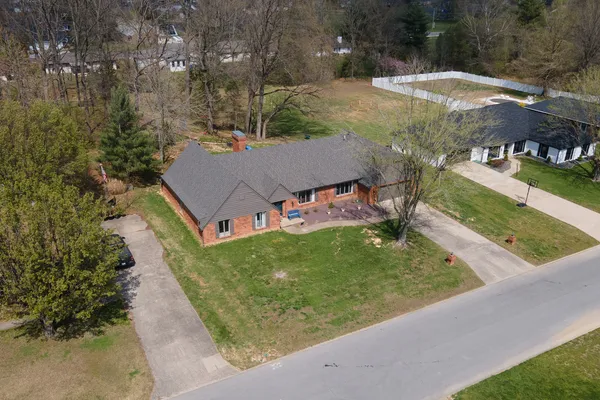 an aerial view of a house with a yard and garden