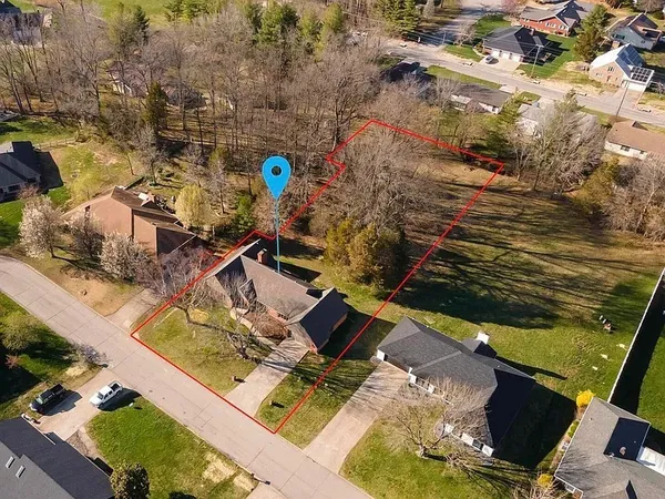 an aerial view of residential houses with outdoor space