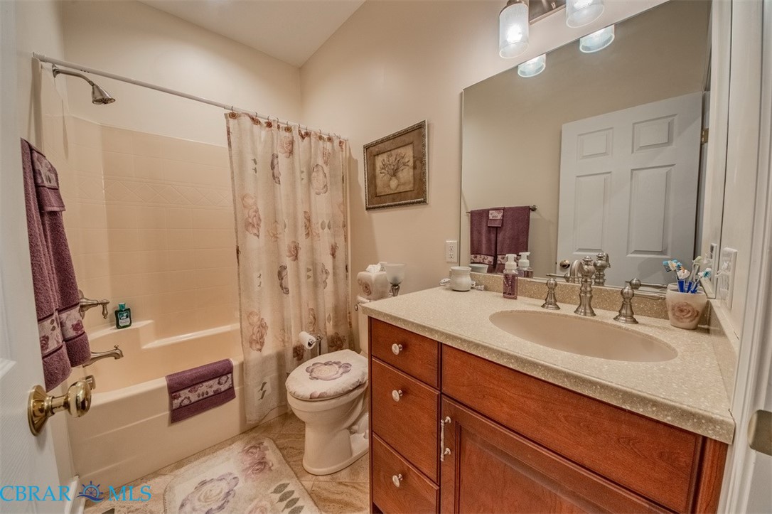 120 North Shore Road Locust Hill, VA 23092 - Photo 22 of 39 Full bath featuring vanity, shower / bath combo with shower curtain, and light tile patterned flooring