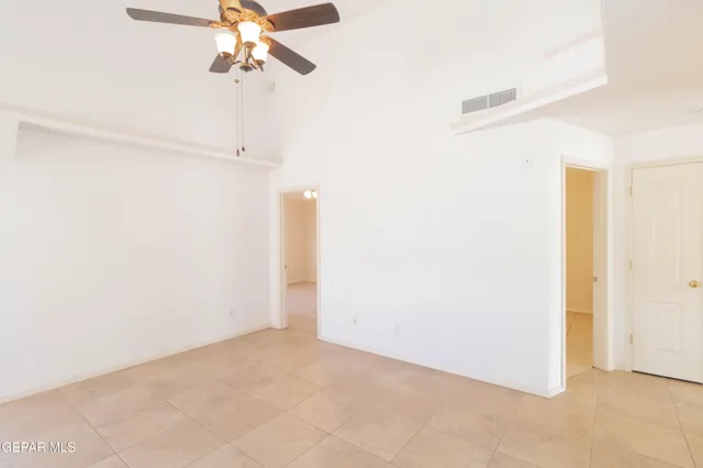 a view of a room with a ceiling fan