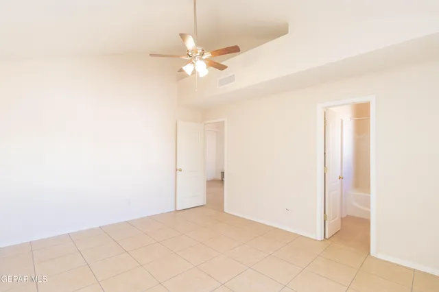 a view of an empty room with a fan