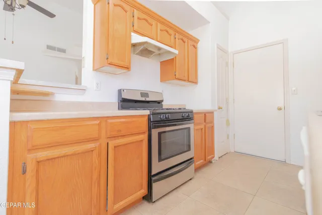 a kitchen with stainless steel appliances white cabinets and a stove