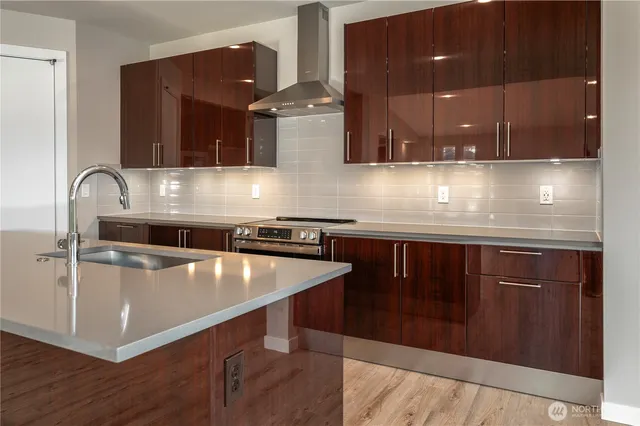 a kitchen with stainless steel appliances granite countertop a sink wooden cabinets and a granite counter tops