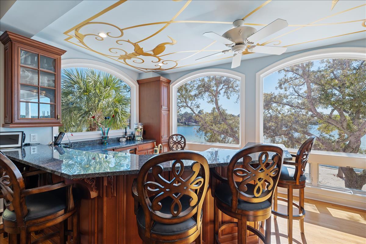 83 Poquito Road Shalimar, FL 32579 - Photo 18 of 83 a view of a dining room with furniture wooden floor and chandelier