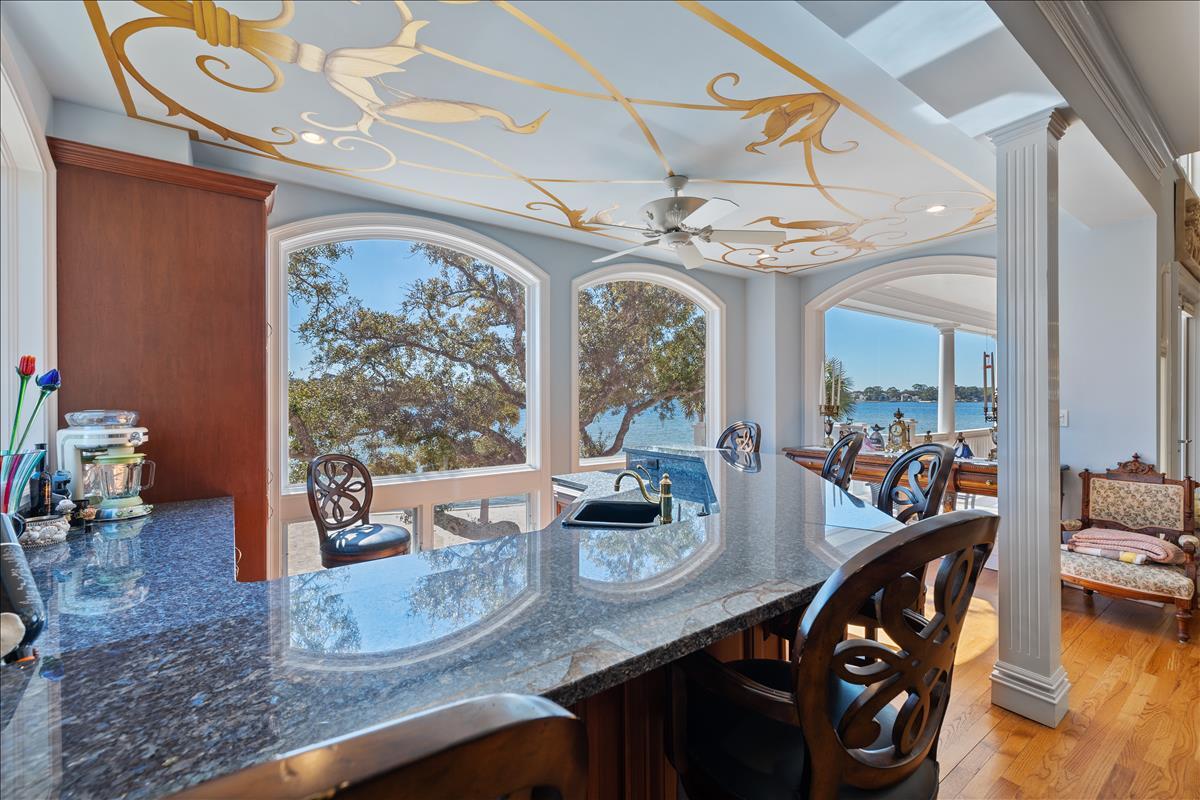 83 Poquito Road Shalimar, FL 32579 - Photo 19 of 83 a view of a dining room and livingroom with furniture wooden floor a chandelier