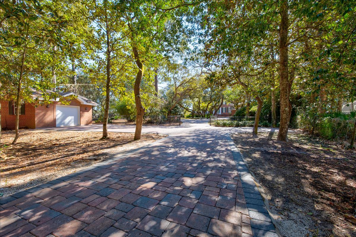 83 Poquito Road Shalimar, FL 32579 - Photo 3 of 83 a view of a yard with plants and trees