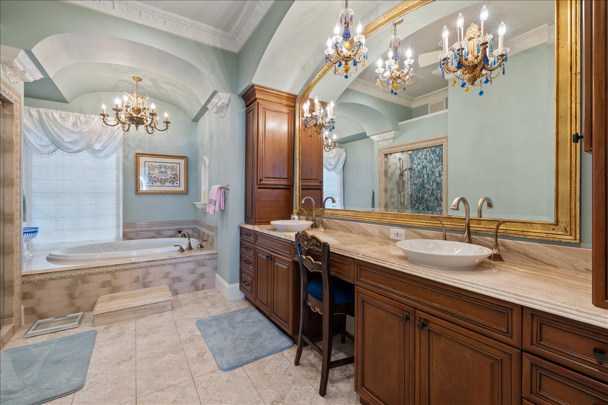 83 Poquito Road Shalimar, FL 32579 - Photo 42 of 83 a bathroom with a granite countertop sink a large mirror and a bathtub