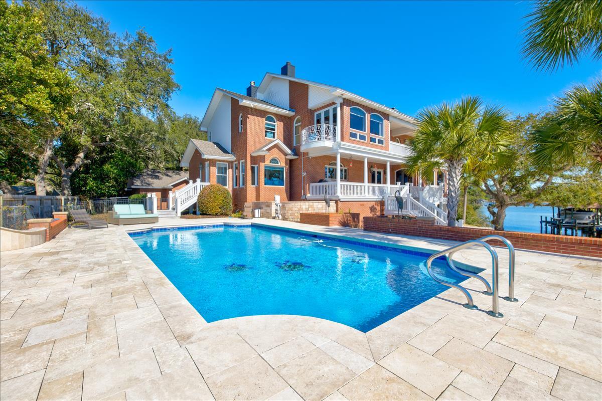 83 Poquito Road Shalimar, FL 32579 - Photo 67 of 83 a view of a swimming pool with a lounge chairs