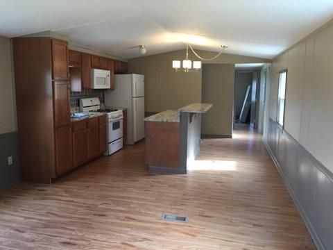 106 Bish Road Butler, PA 16002 - Photo 4 of 9 a kitchen with stainless steel appliances granite countertop a refrigerator and a stove top oven