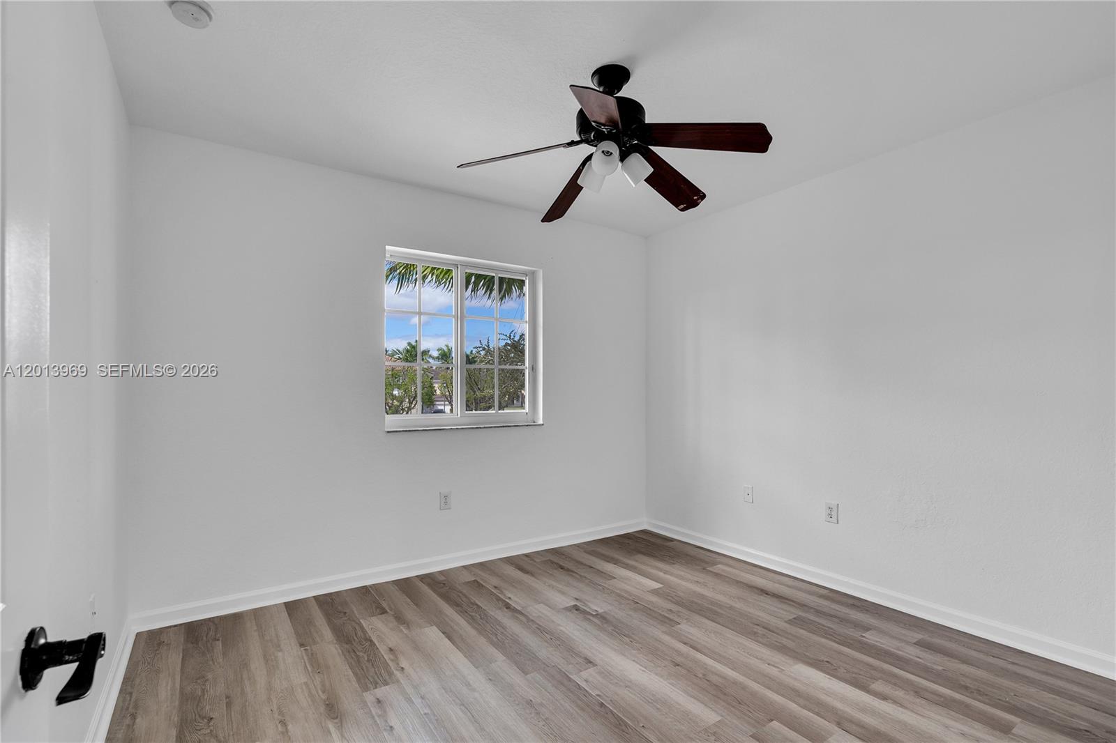 14044 Southwest 273rd Lane, Unit 14044 Homestead, FL 33032 - Photo 27 of 44 a view of empty room with wooden floor