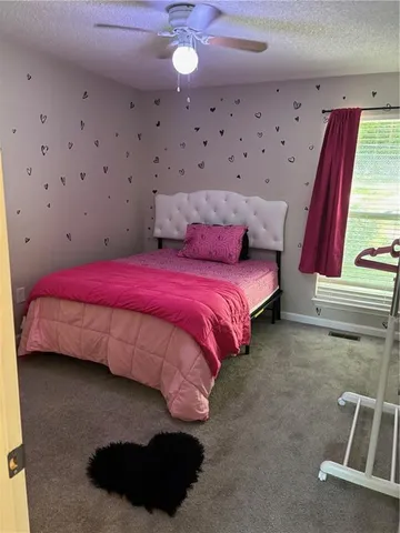 a bed room with a bed and a chair