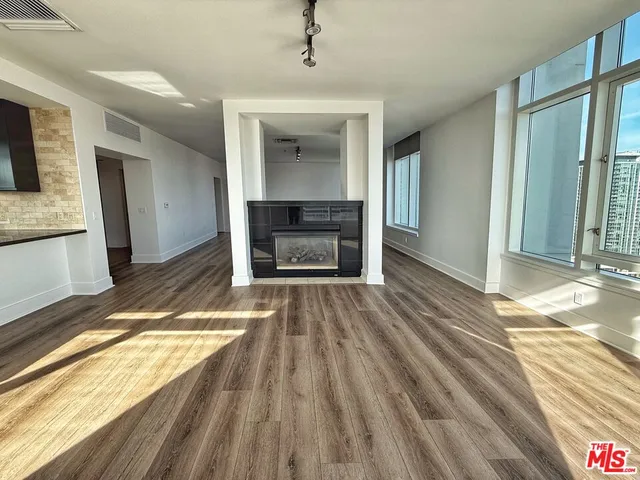 a view of a livingroom with a fireplace and wooden floor