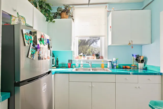 a kitchen with stainless steel appliances a refrigerator and a sink