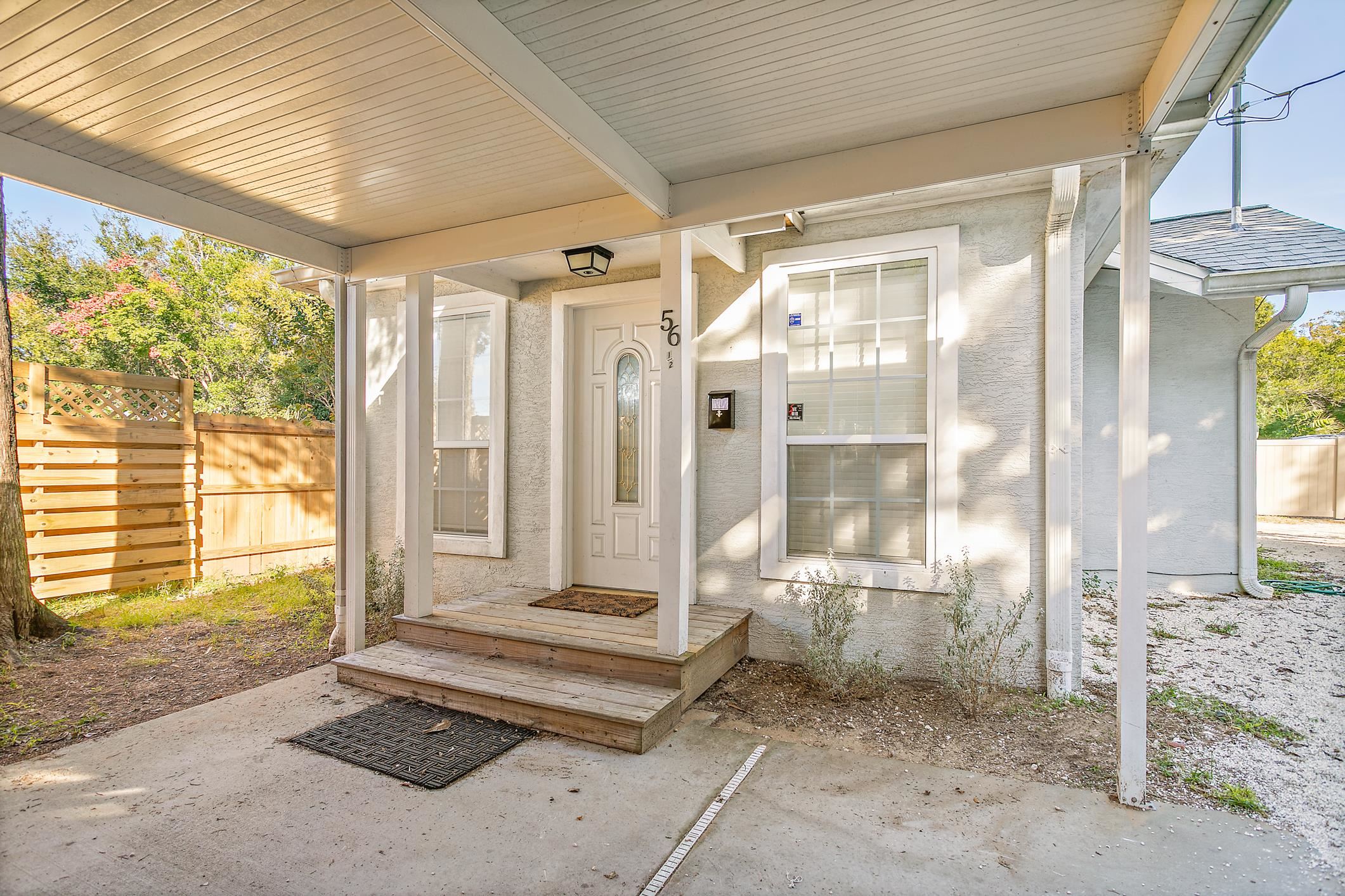 56 Grove Avenue St. Augustine, FL 32084 - Photo 15 of 48 a bathroom with a tub that has a glass door shower