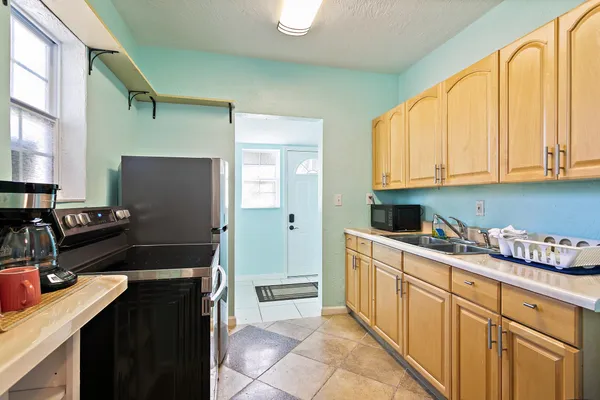 a kitchen with a refrigerator stove and sink