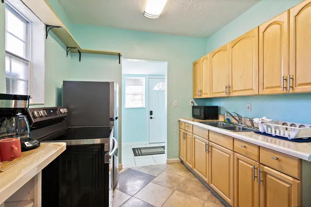a kitchen with a refrigerator stove and sink