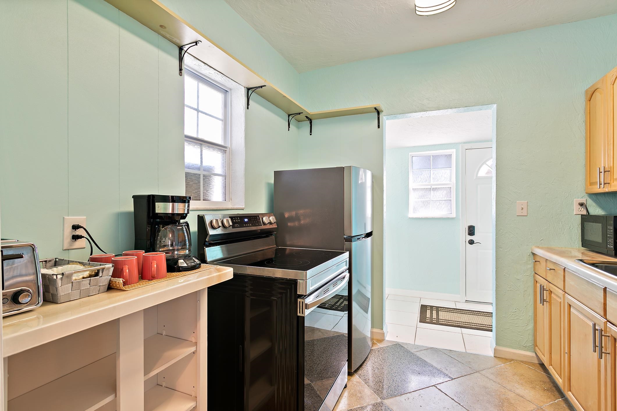 56 Grove Avenue St. Augustine, FL 32084 - Photo 24 of 48 a kitchen with a refrigerator stove and sink