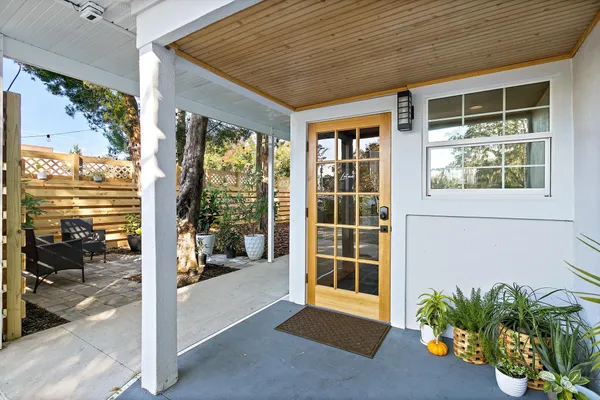 a dining hall with stainless steel appliances a table and chairs