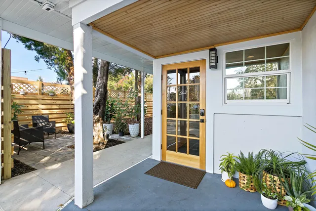 a dining hall with stainless steel appliances a table and chairs