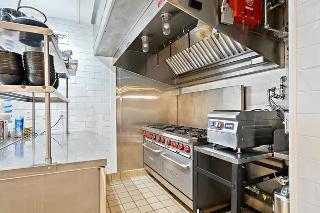 a kitchen with stainless steel appliances granite countertop a sink and a refrigerator