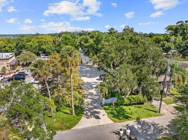 an aerial view of a house with a yard and garden