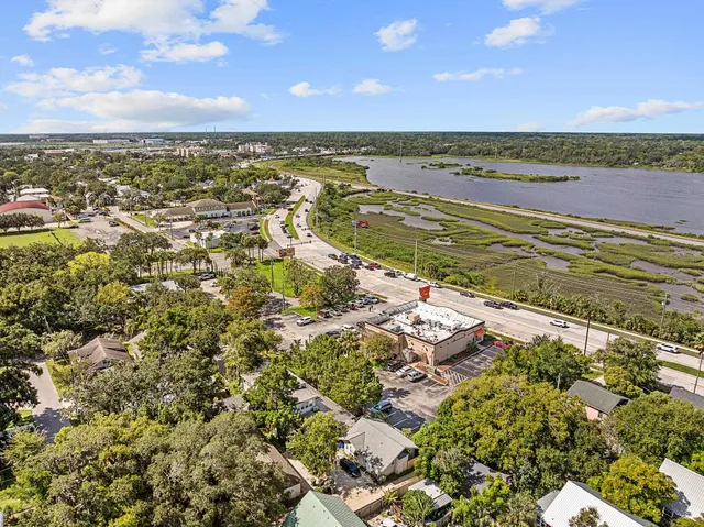 an aerial view of a house with a yard and lake view