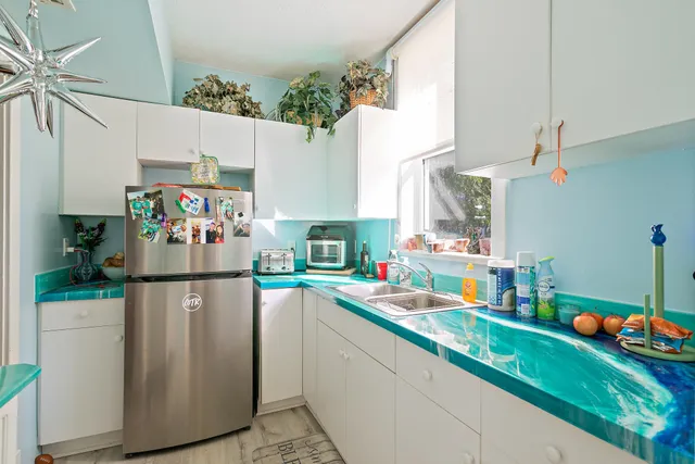 a kitchen with stainless steel appliances granite countertop a refrigerator and a sink