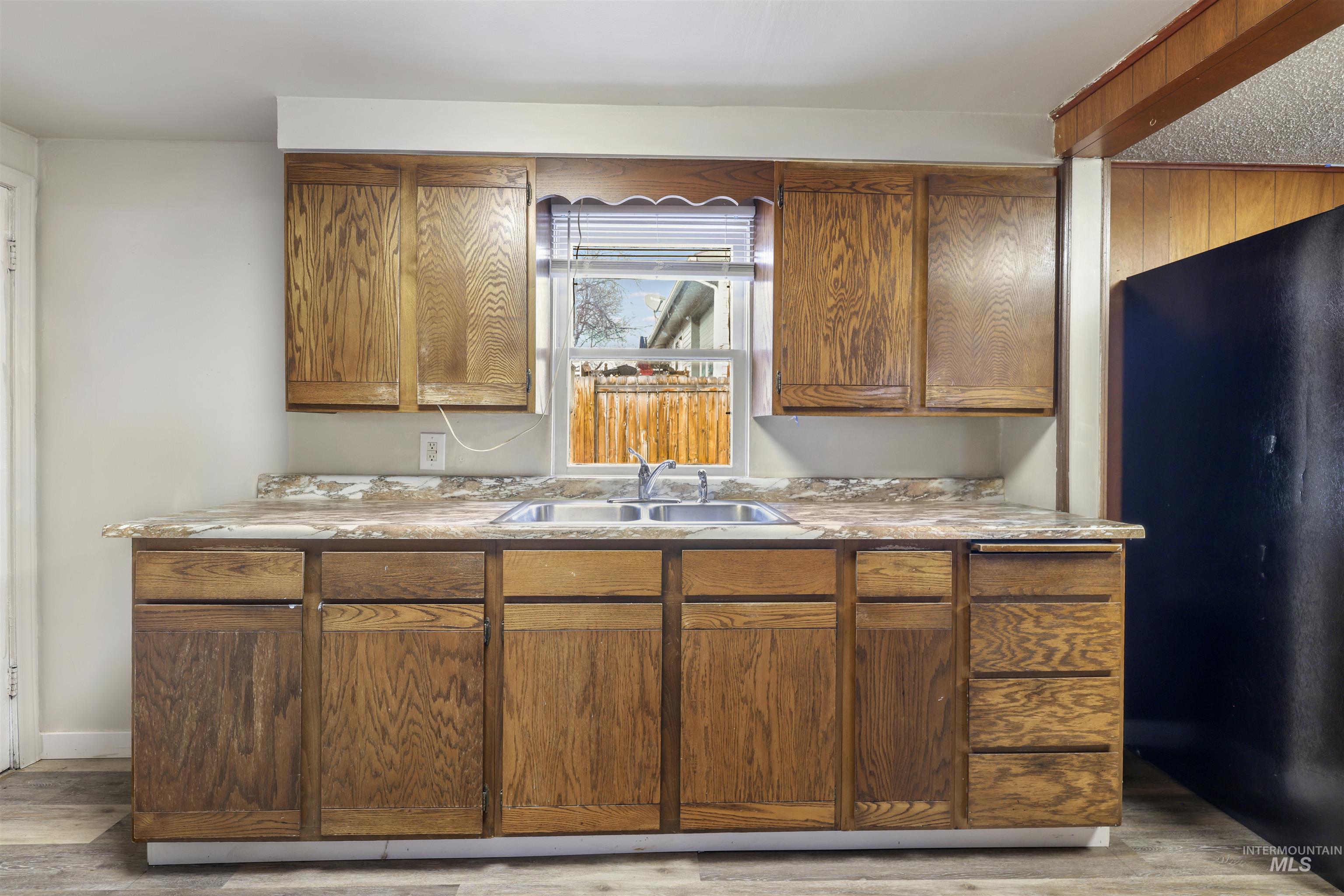 545 Madison Street Twin Falls, ID 83301 - Photo 6 of 23 Kitchen featuring freestanding refrigerator, brown cabinets, light countertops, and light wood-style flooring