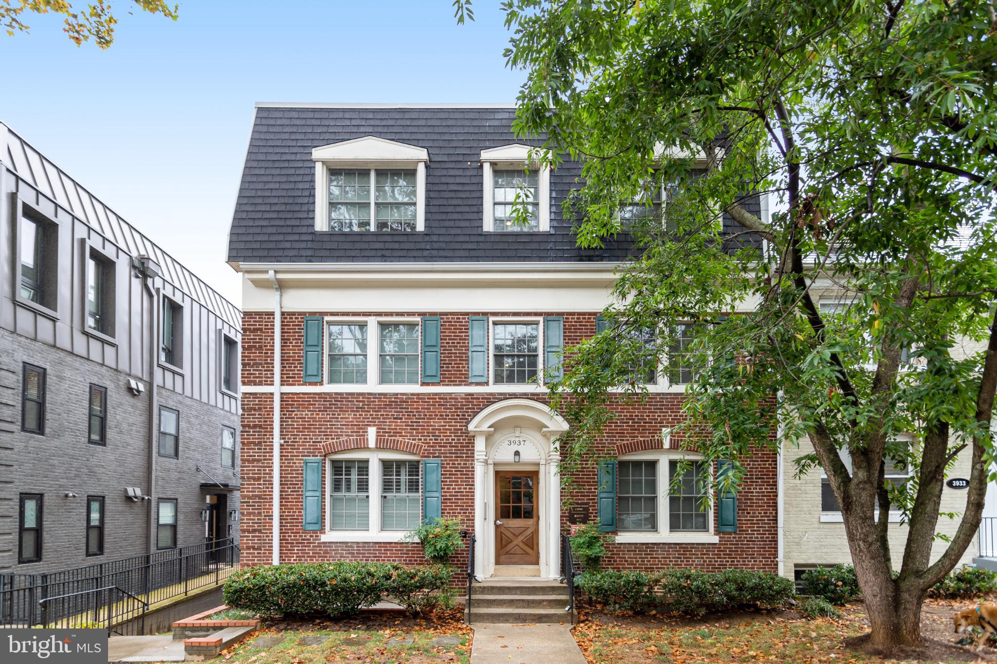 3937 Davis Place Northwest, Unit 1 Washington, DC 20007 - Photo 1 of 22 front view of a brick house with a large windows and a tree
