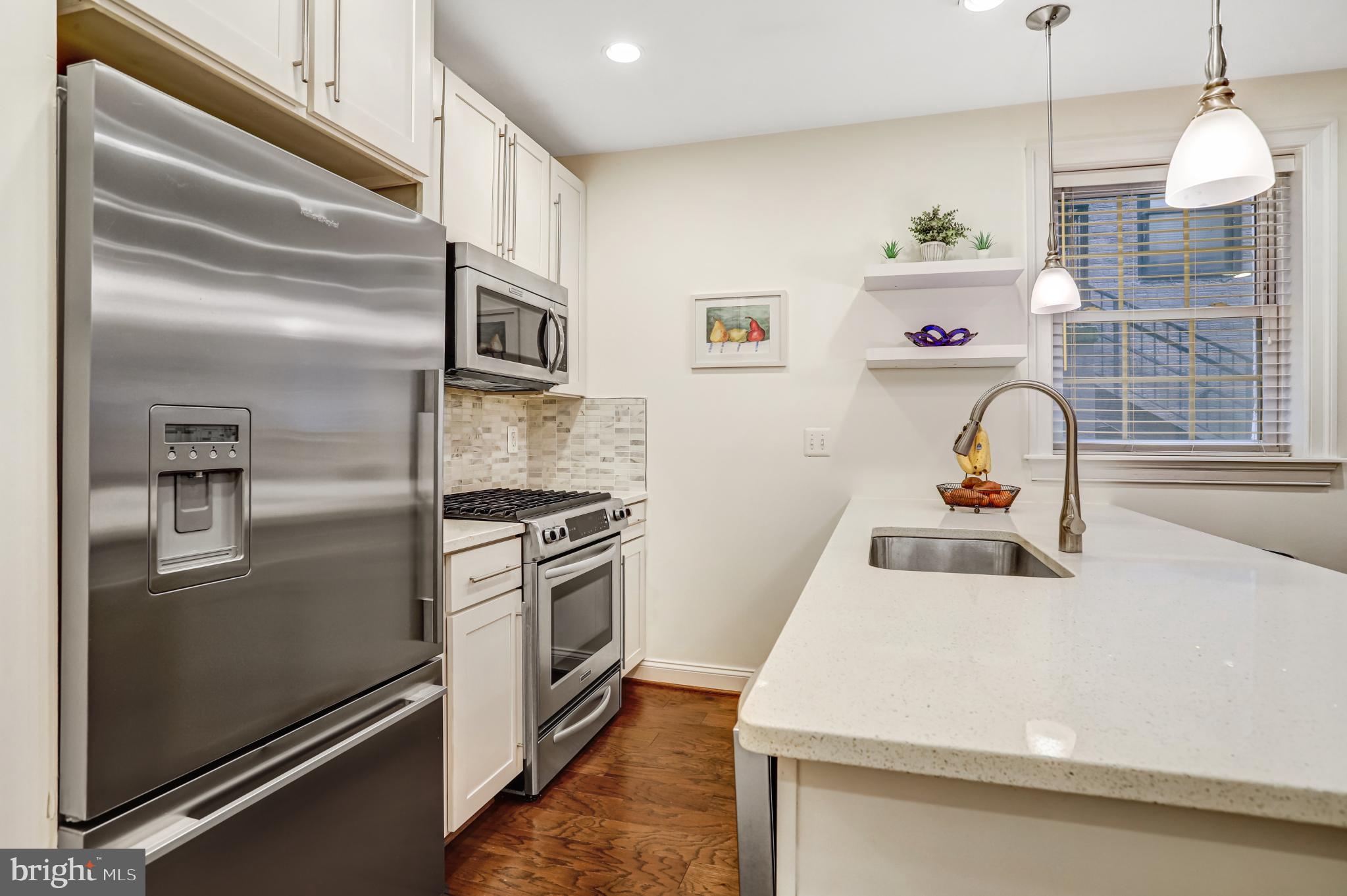 3937 Davis Place Northwest, Unit 1 Washington, DC 20007 - Photo 9 of 22 a kitchen with a refrigerator stove and a sink