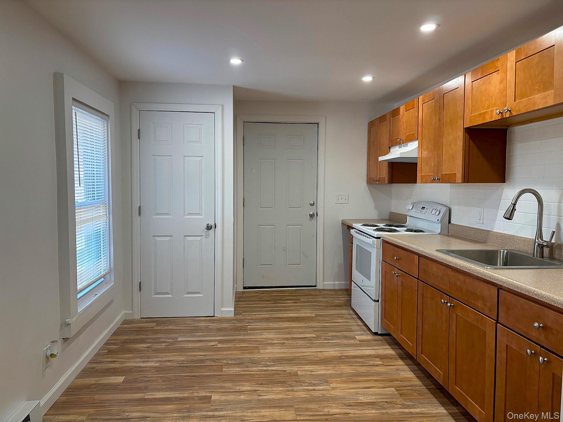 447 Highway 376, Unit 2 Hopewell Junction, NY 12533 - Photo 3 of 12 a bathroom with a sink a mirror and a shower