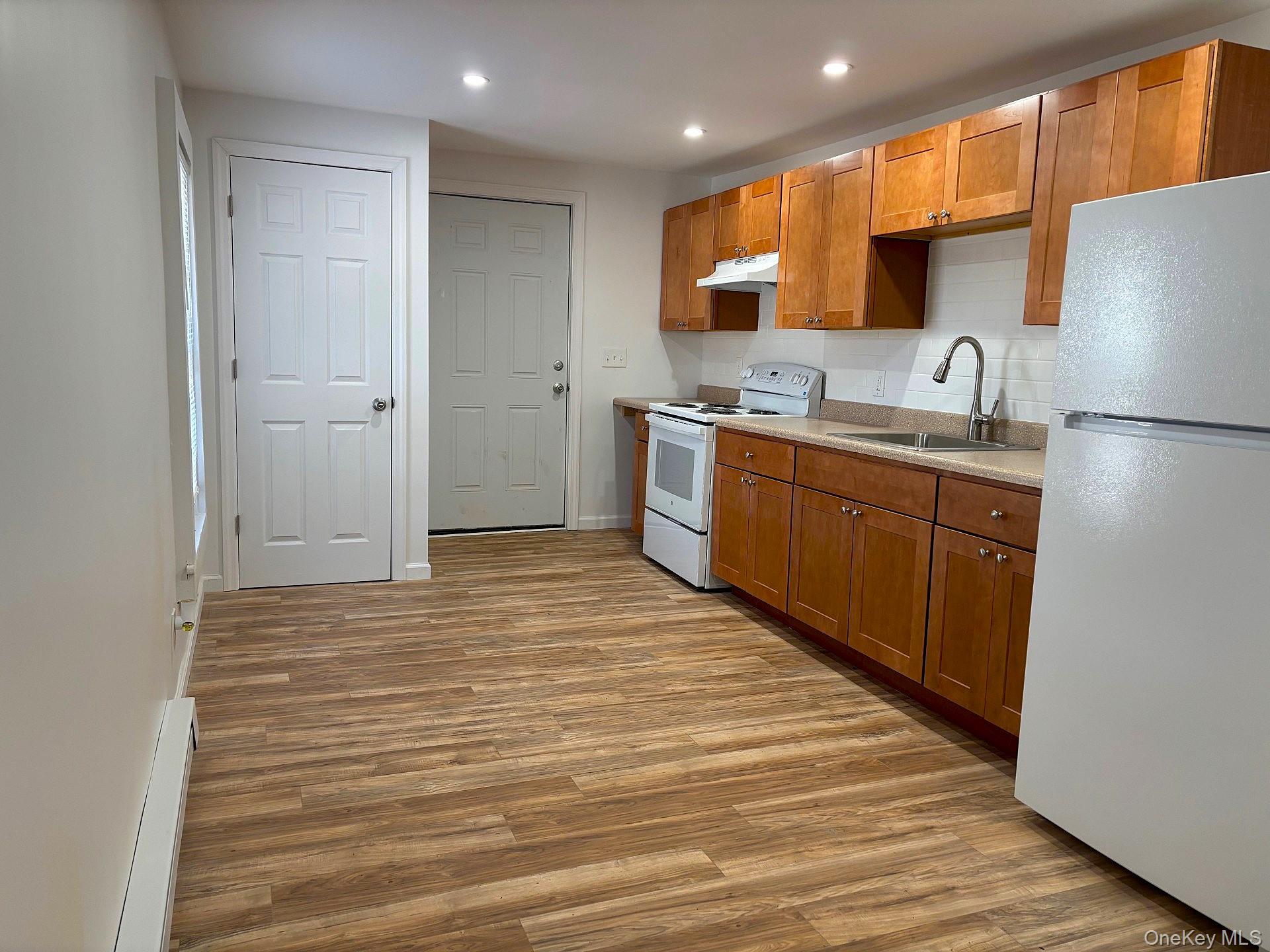 447 Highway 376, Unit 2 Hopewell Junction, NY 12533 - Photo 4 of 12 a kitchen with stainless steel appliances granite countertop a sink and cabinets