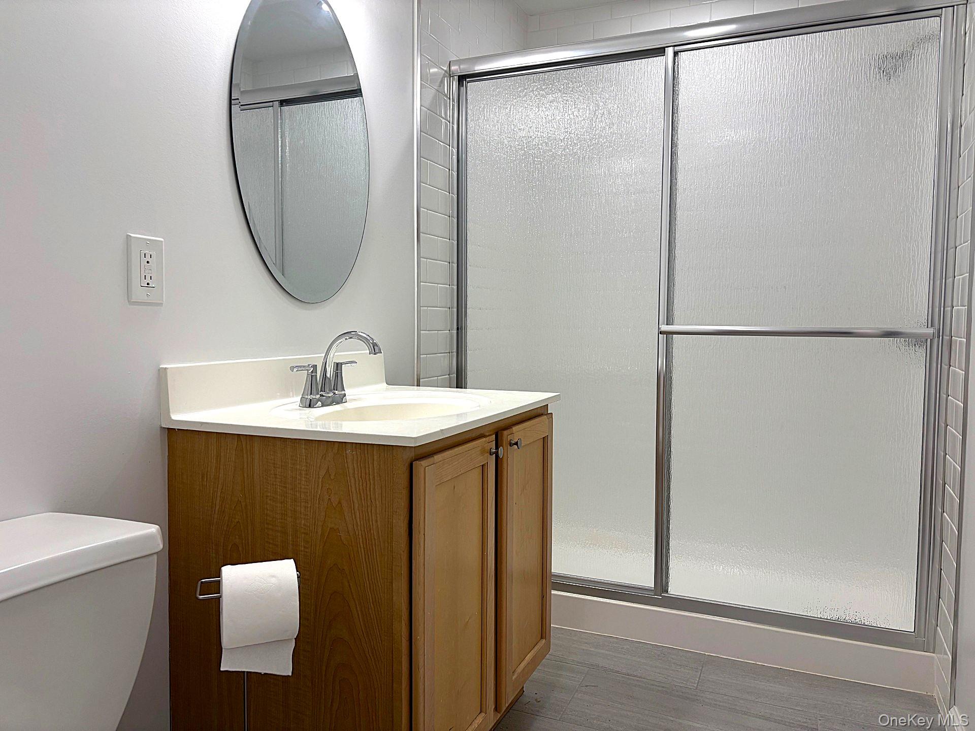 447 Highway 376, Unit 2 Hopewell Junction, NY 12533 - Photo 7 of 12 a bathroom with a sink toilet and a mirror